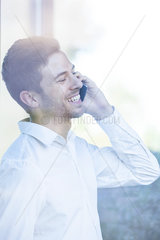Businessman receiving good news phone call
