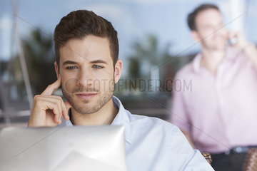 Man contemplating while using laptop computer