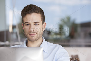 Businessman using laptop computer outdoors