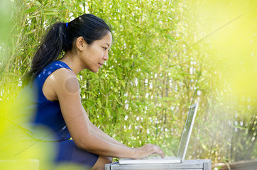 Woman using laptop computer outdoors