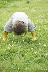 Child playing in grassy field