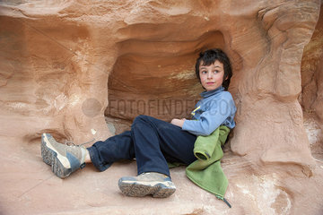 Boy relaxing on rock formation at Capitol Reef National Park  Utah  USA