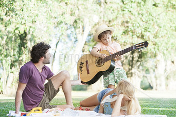Parents teaching son how to play guitar