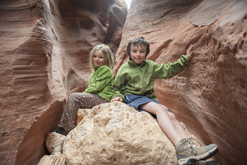 Children sitting on rock formation in Utah  USA