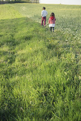Children walking in field