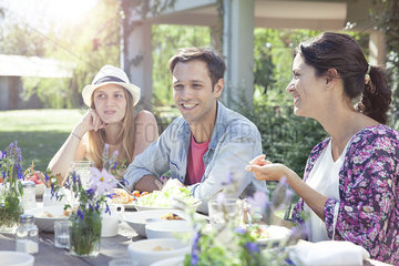 Friends chatting while enjoying healthy meal together