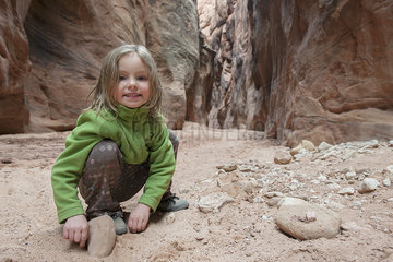 Girl looking at rocks  portrait