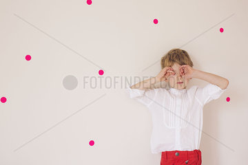 Little boy covering eyes with his hands  portrait
