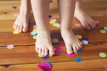 Barefeet and confetti on hardwood floor
