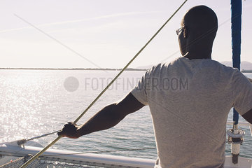 Man on sail boat  looking at view