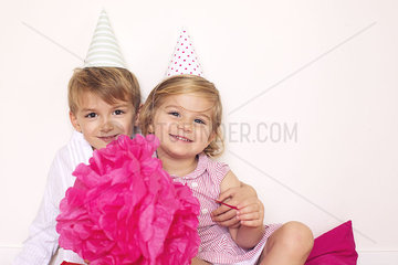 Brother and sister at birthday party  portrait