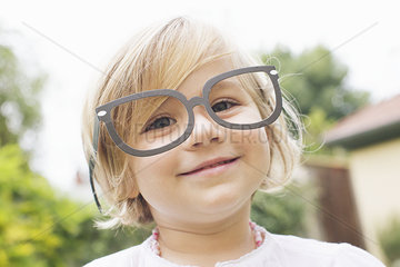Little girl wearing costume glasses