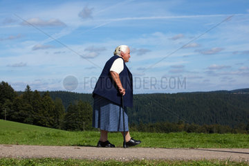 Sankt Maergen  Deutschland  eine Rentnerin mit Stock beim Spazieren