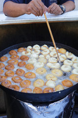 Inca  Mallorca  Spanien  Teigkringel werden auf einem Wochenmarkt in Oel frittiert