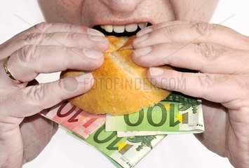Symbolbild Gier  Geld essen