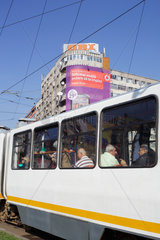 Bukarest  Rumaenien  Strassenbahn mit Fahrgaesten  im Hintergrund Obi-Werbung