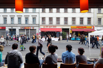 Berlin  Deutschland  Gaeste in einem Cafe beobachten Passanten in der Oranienstrasse