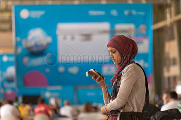 Berlin  Deutschland  Muslima mit Iphone auf der Campus Party Europe