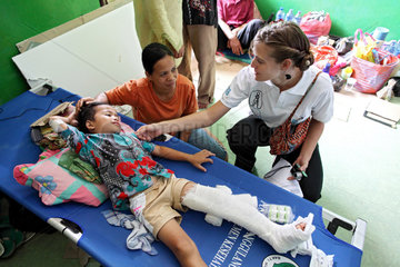 Pariaman  Indonesien  Mitarbeiterin von Handicap International im Hospital bei einem verletzten Jungen