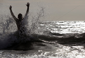 Kaegsdorf  Deutschland  Silhouette  Mann springt aus dem Meer heraus