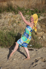 Kaegsdorf  Deutschland  in ein Badetuch gehuellte Frau am Strand