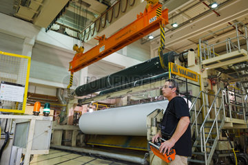 Doerpen  Deutschland  Mitarbeiter der Firma Nordland Papier bewegt per Kran eine Papierwalze