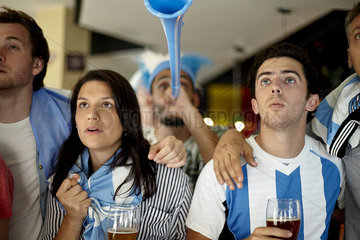 Argentinian football supporters watching match in bar