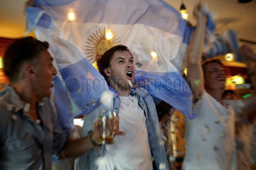 Argentinian football fans celebrating in bar