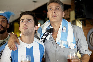Argentinian football supporters watching match in bar