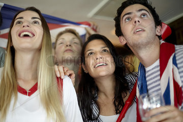 British football fans watching match in bar
