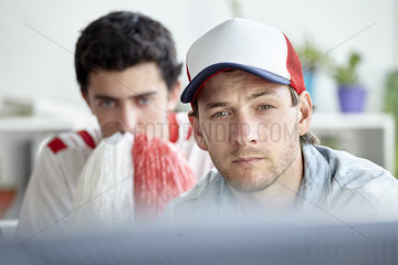 Sports fans watching match on TV