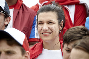 Woman smiling cheerfully at football match
