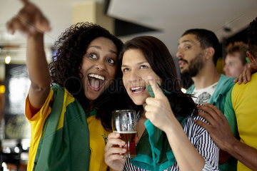 Brazilian football supporters watching match in bar