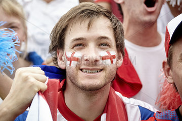 British football fan smiling at match  portrait
