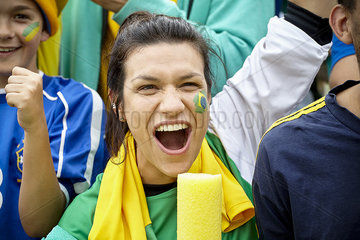 Brazilian football fan cheering at match