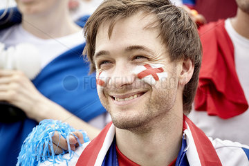 British football fan smiling cheerfully at match  portrait