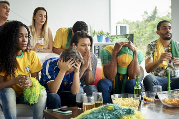 Brazilian football fans watching football match at home