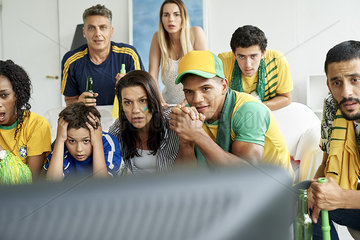 Brazilian soccer fans watching televised match together