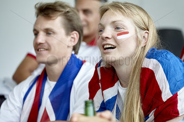 British football fans watching match at home