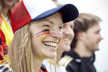 German football fan smiling at match
