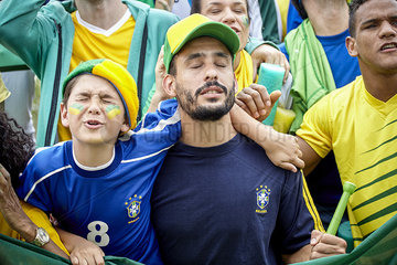 Brazilian football fans looking upset at football match