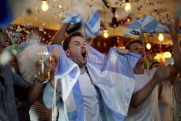Argentinian football fans celebrating victory in bar