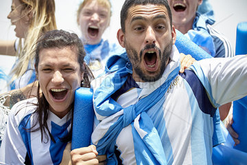 Excited Argentinian football fans at match