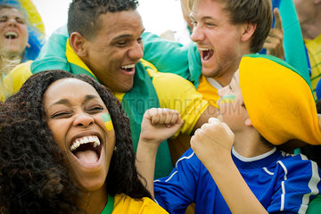 Brazilian football fans celebrating victory at match