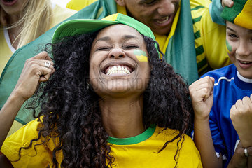 Brazilian football fans cheering at match