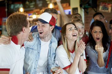 English soccer fans watching math together at pub