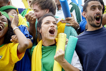Brazilian football fans celebrating victory at football match