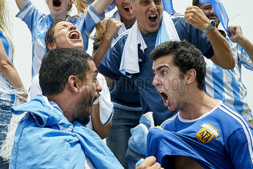 Argentinian football fans cheering while watching football match