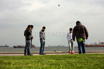 Istanbul  Tuerkei  junge Maenner sonntags auf der Promenade am Marmarameer