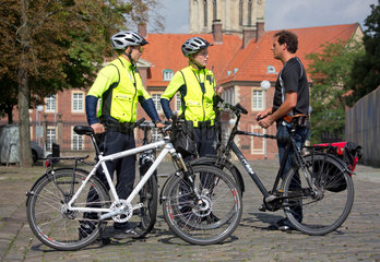 Muenster  Deutschland  Polizisten auf Fahrradstreife kontrollieren einen Fahrradfahrer